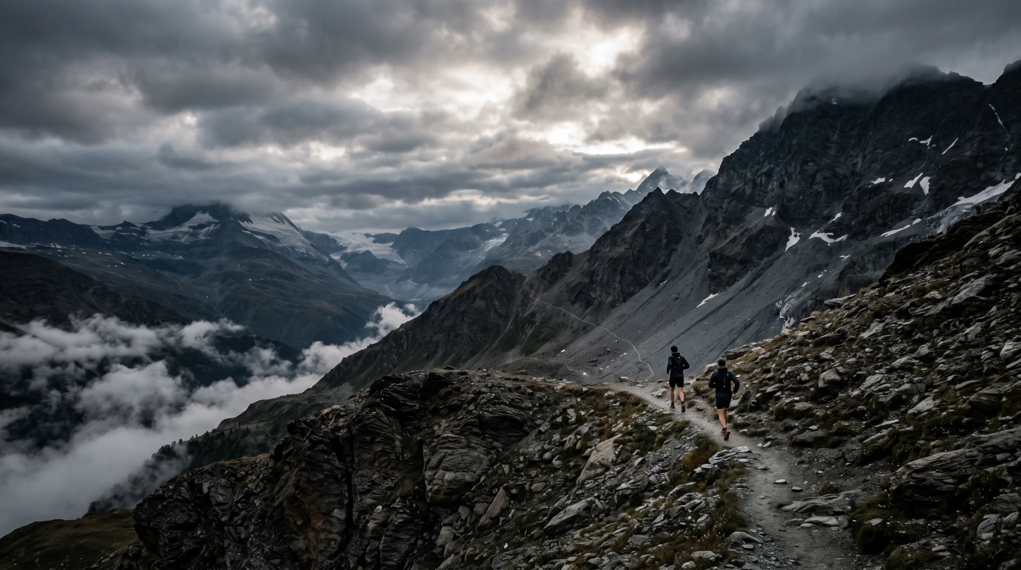 Two runners on a high mountain trail under storm clouds